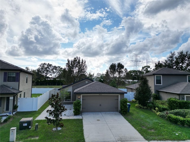 view of front of house with a garage and a front yard