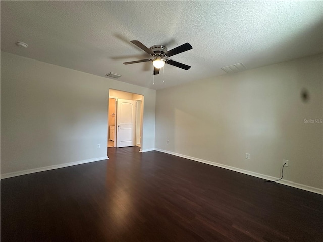 spare room with a textured ceiling, dark hardwood / wood-style floors, and ceiling fan