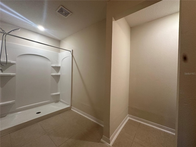 bathroom featuring tile patterned floors and walk in shower