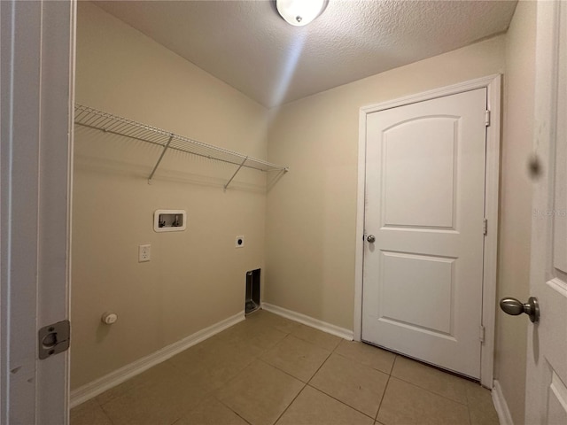 laundry room featuring electric dryer hookup, light tile patterned floors, a textured ceiling, and hookup for a washing machine