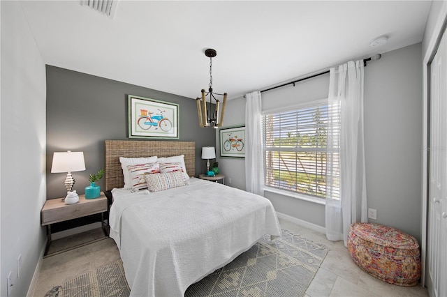 bedroom featuring a notable chandelier and a closet