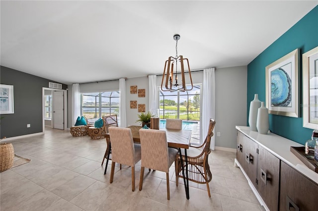 dining area featuring a chandelier and light tile patterned floors