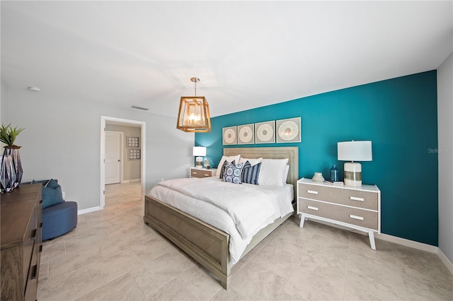 bedroom featuring an inviting chandelier