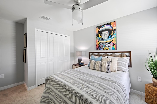 bedroom with light tile patterned flooring, a closet, and ceiling fan