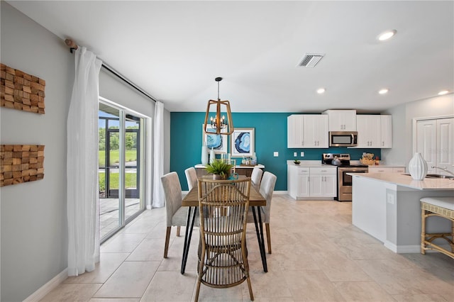 dining area with an inviting chandelier and light tile patterned floors