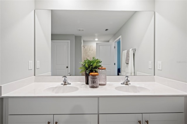 bathroom with walk in shower and vanity