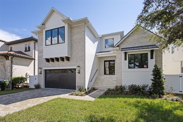 view of front of home featuring a front lawn and a garage