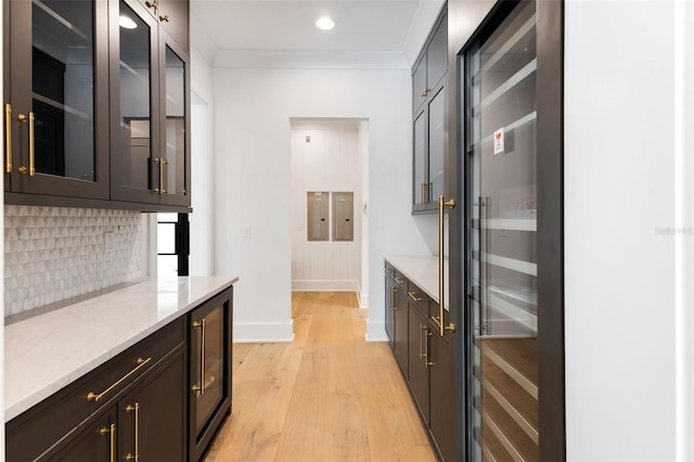 bar with beverage cooler, crown molding, backsplash, and light hardwood / wood-style flooring