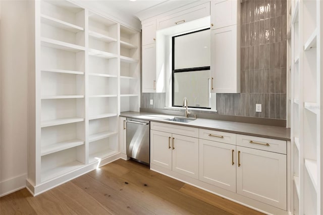 kitchen with dishwasher, light hardwood / wood-style flooring, white cabinets, and sink