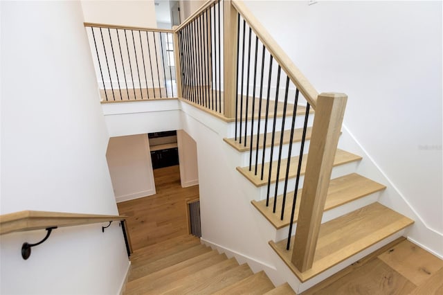 stairs featuring wood-type flooring