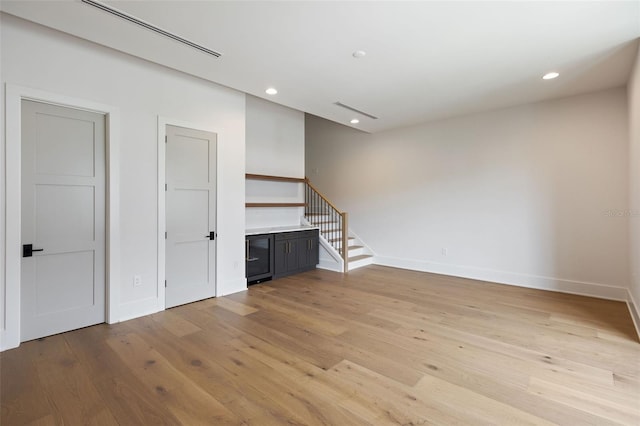 unfurnished living room with light hardwood / wood-style flooring