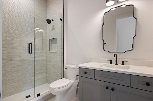 bathroom featuring walk in shower, vanity, and toilet