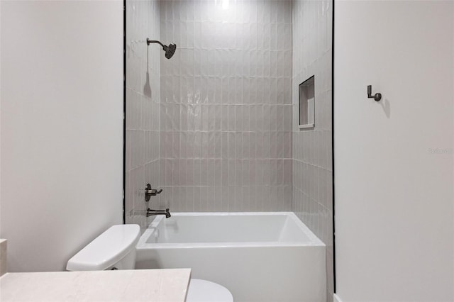 full bathroom featuring vanity, toilet, and tiled shower / bath combo