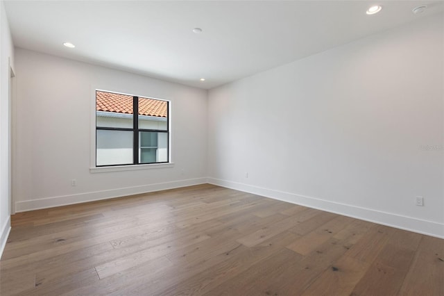 unfurnished room featuring hardwood / wood-style flooring