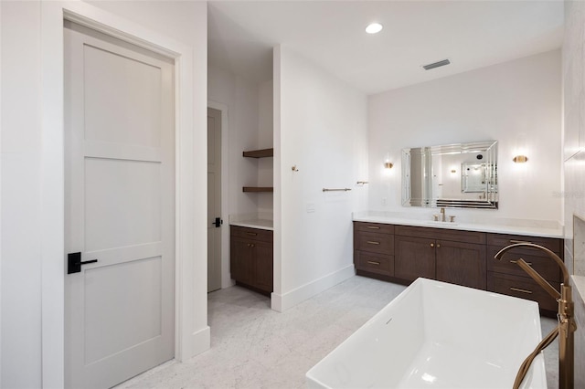 bathroom with vanity and a bathing tub