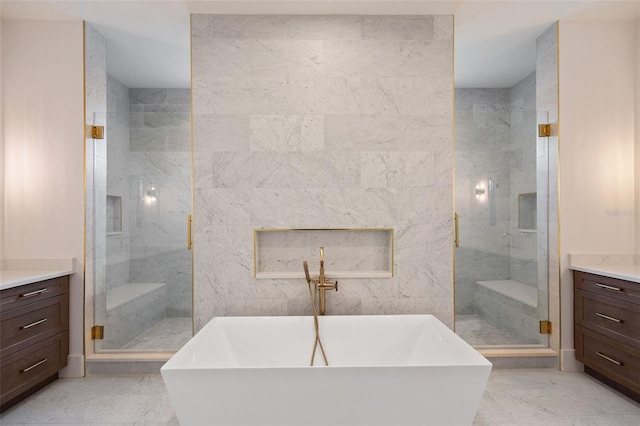 bathroom featuring separate shower and tub, vanity, and tile walls