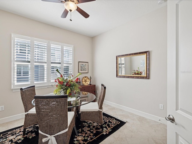 dining space featuring light tile patterned flooring and ceiling fan