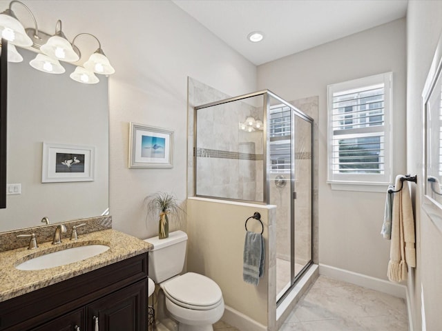 bathroom with vanity, toilet, and walk in shower