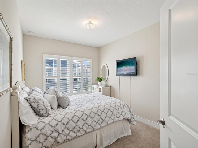 carpeted bedroom with a textured ceiling