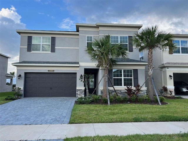 view of front of house featuring a front yard and a garage