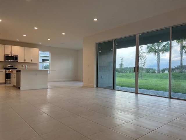 unfurnished living room featuring light tile patterned floors