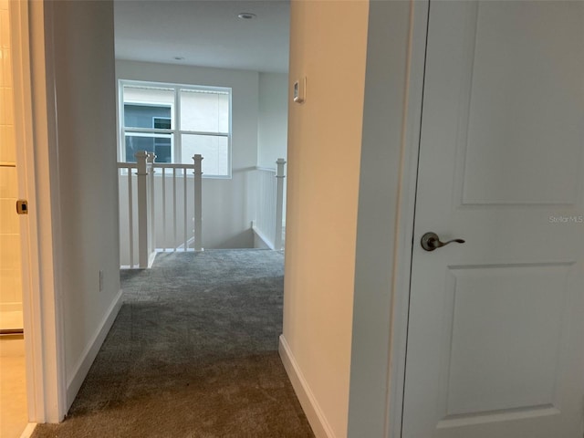 hallway with dark carpet