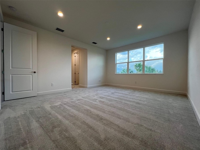 unfurnished room with light carpet