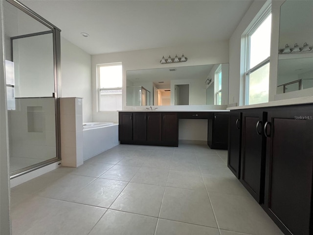 bathroom featuring tile patterned floors, vanity, and shower with separate bathtub