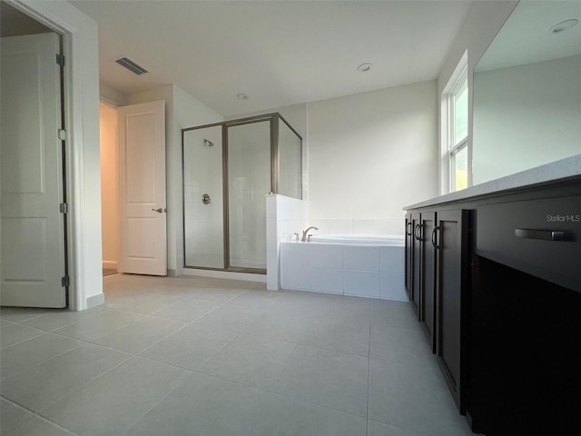 bathroom with tile patterned floors and independent shower and bath