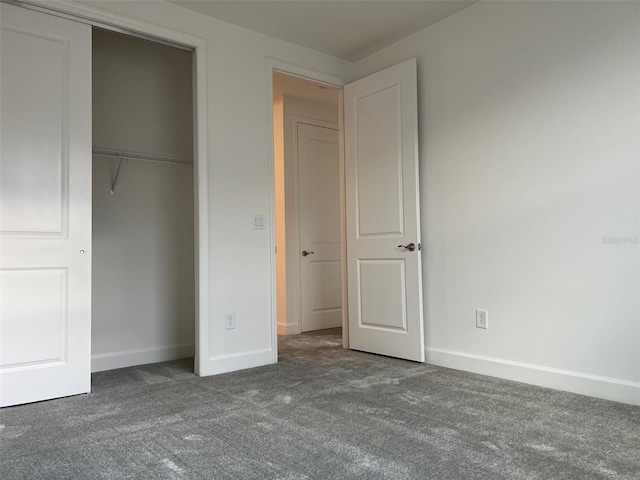 unfurnished bedroom featuring carpet and a closet