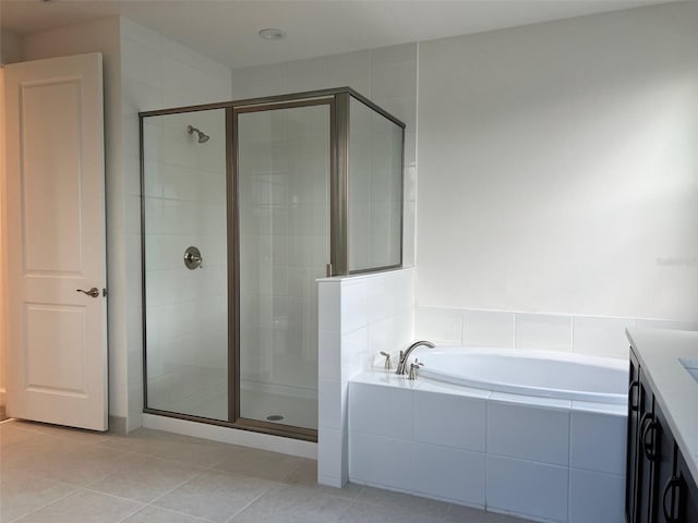 bathroom with tile patterned floors, vanity, and independent shower and bath