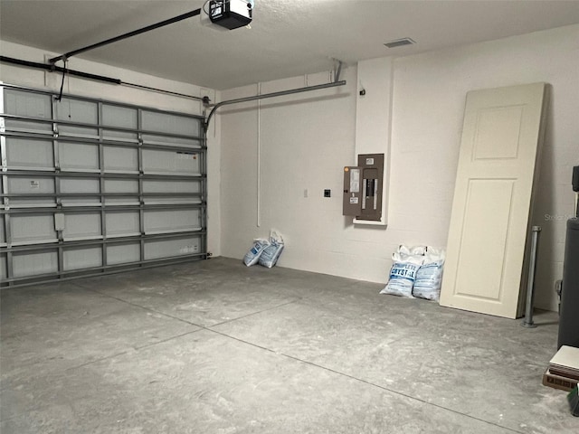 garage with electric panel and a garage door opener