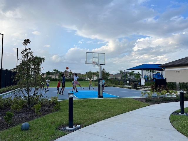 view of basketball court with a lawn