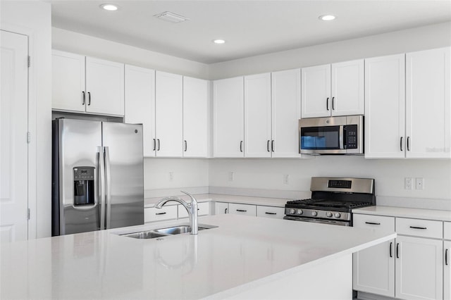 kitchen featuring sink, stainless steel appliances, and white cabinets