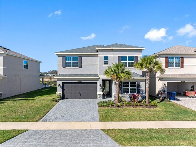 view of front of house with a front lawn and a garage