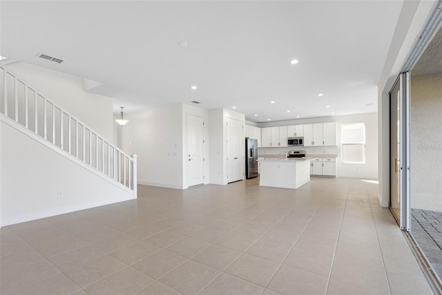 unfurnished living room featuring light tile patterned floors