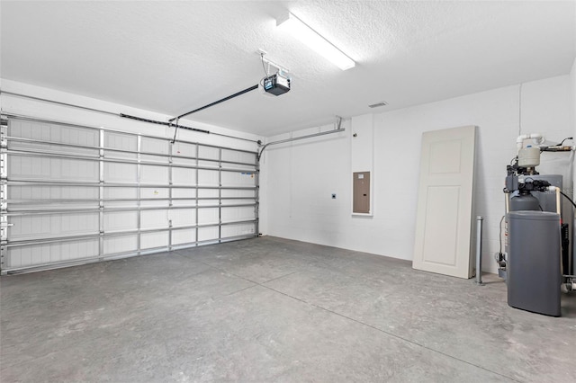 garage with a garage door opener and electric panel