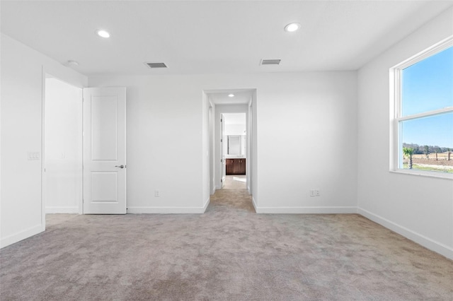 spare room with light colored carpet