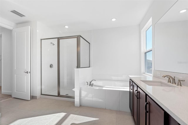 bathroom with separate shower and tub, vanity, and tile patterned flooring