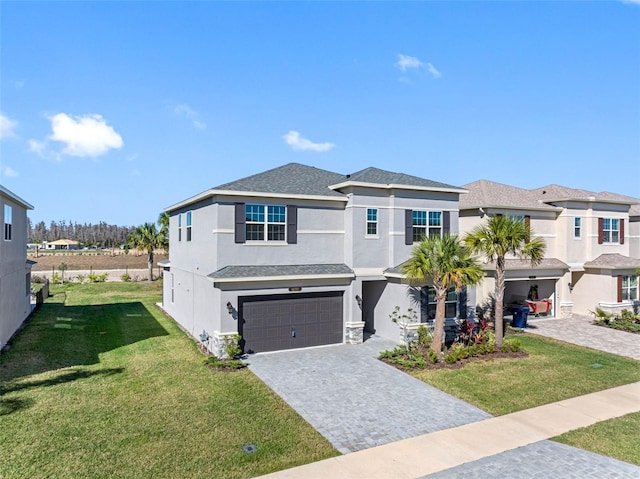 view of front of home with a front yard and a garage