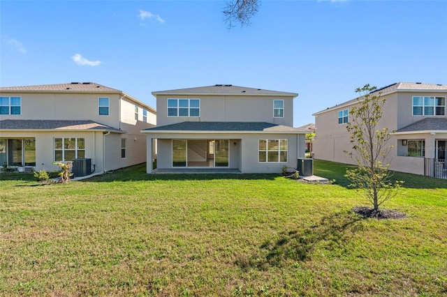 back of property with a yard and central AC unit