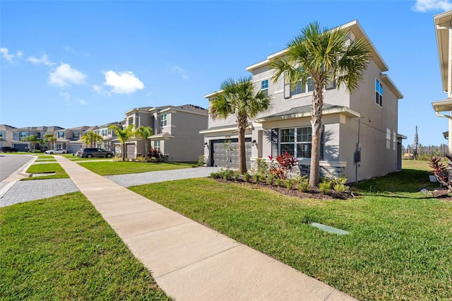 view of front of property featuring a garage and a front yard