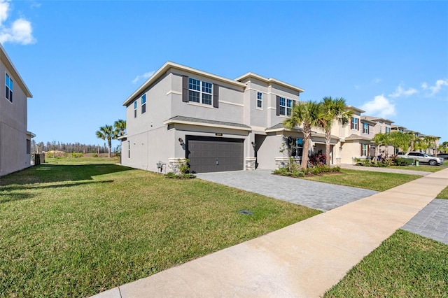 view of front of property featuring a front yard and a garage