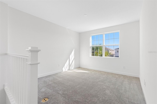 unfurnished room featuring light carpet