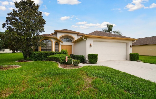 view of front of house featuring a garage and a front lawn