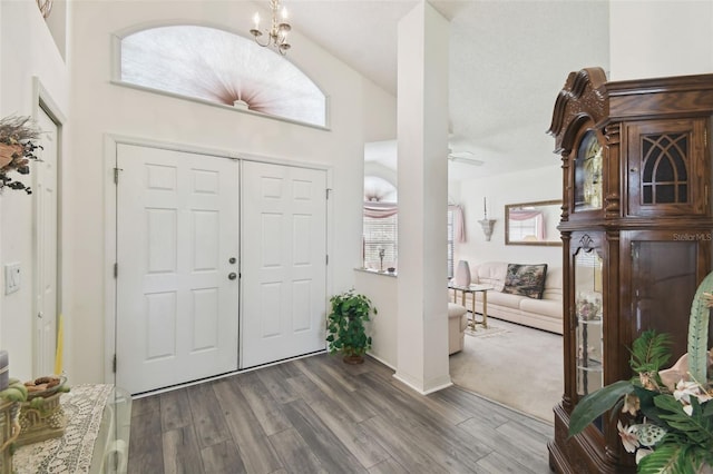 entryway featuring dark wood-type flooring, high vaulted ceiling, and ceiling fan