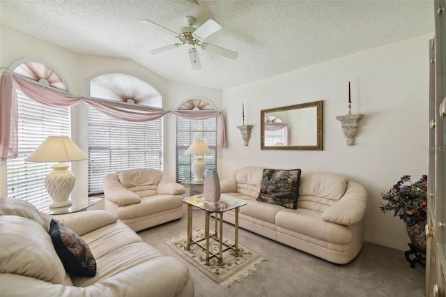 carpeted living room featuring ceiling fan, a textured ceiling, and vaulted ceiling