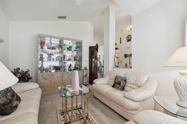 living room featuring lofted ceiling and carpet flooring