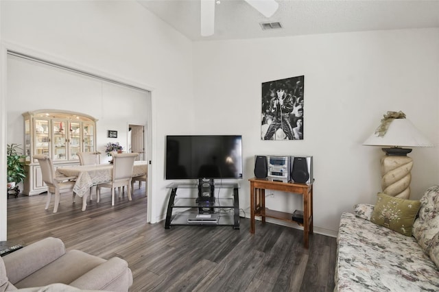 living room featuring ceiling fan, high vaulted ceiling, a textured ceiling, and dark hardwood / wood-style flooring