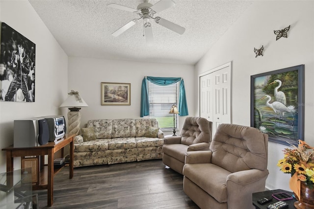 living room with lofted ceiling, a textured ceiling, dark hardwood / wood-style floors, and ceiling fan